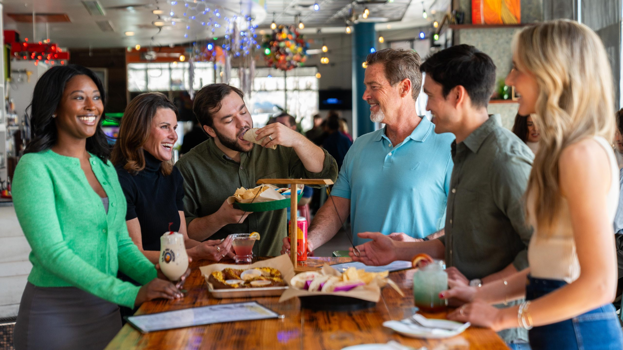 group of people at quirks eating a meal and enjoying happy hour in town center virginia beach