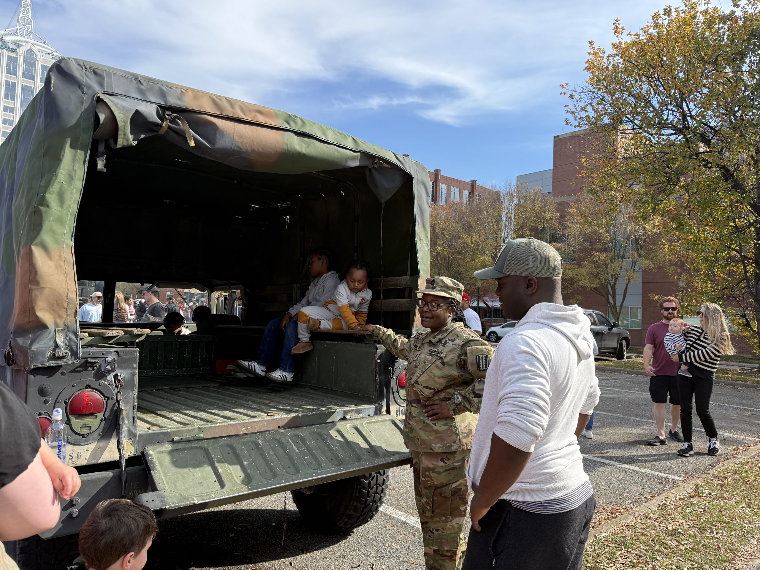 touch a truck at town center virginia beach showing army vehicle and troop with kid in back exploring